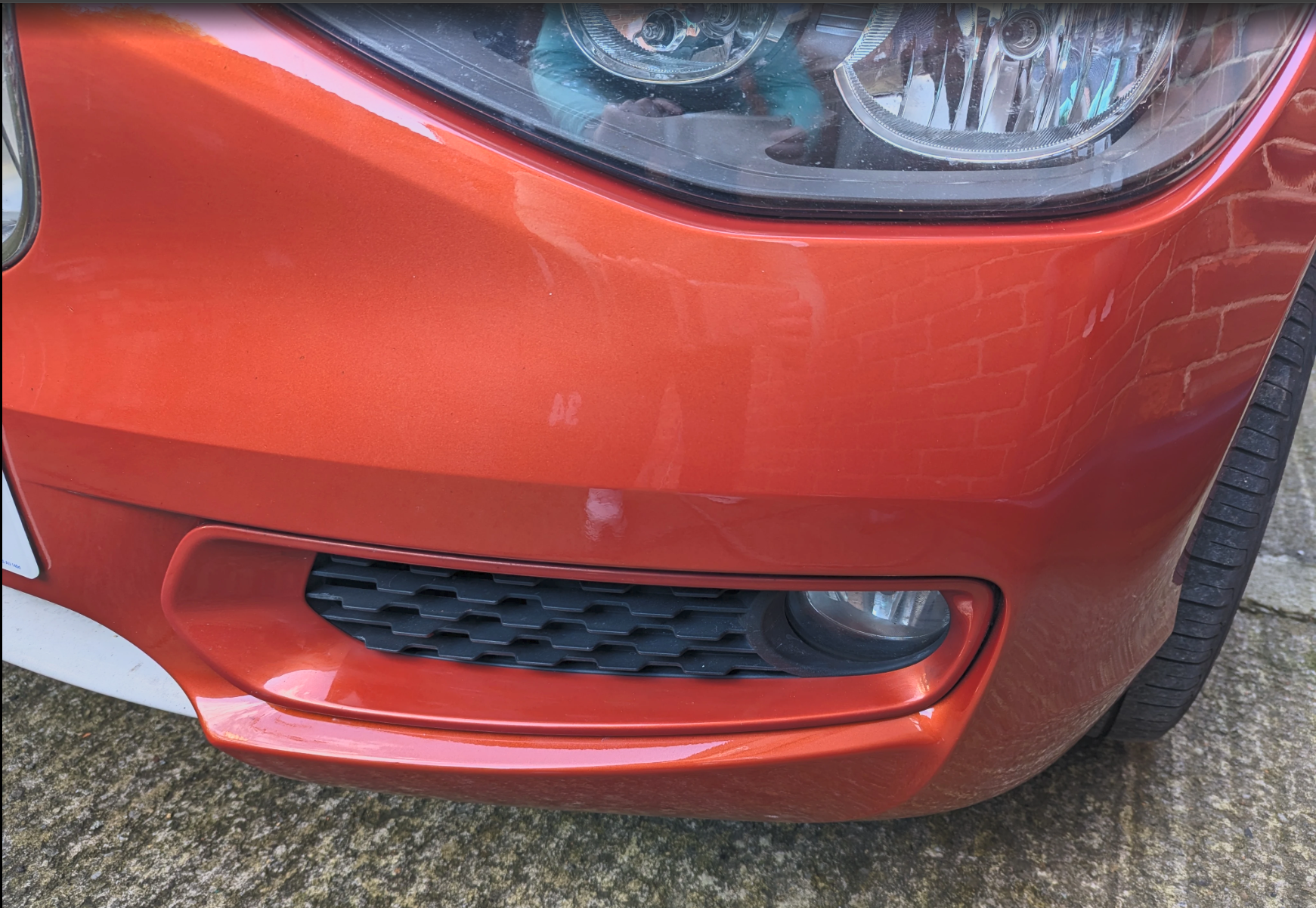 Orange bumper scuff after professional repair