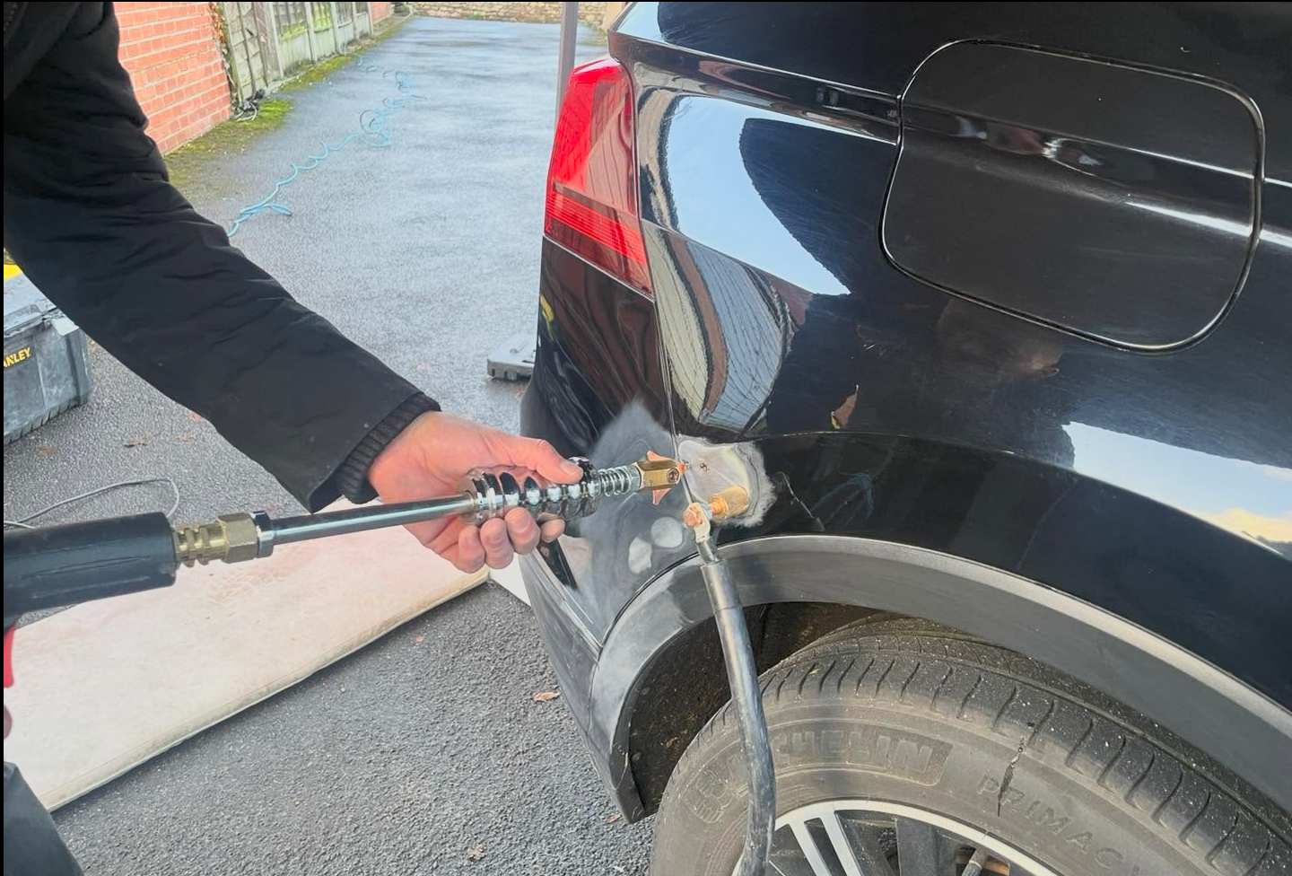 Car dent repair specialist at work