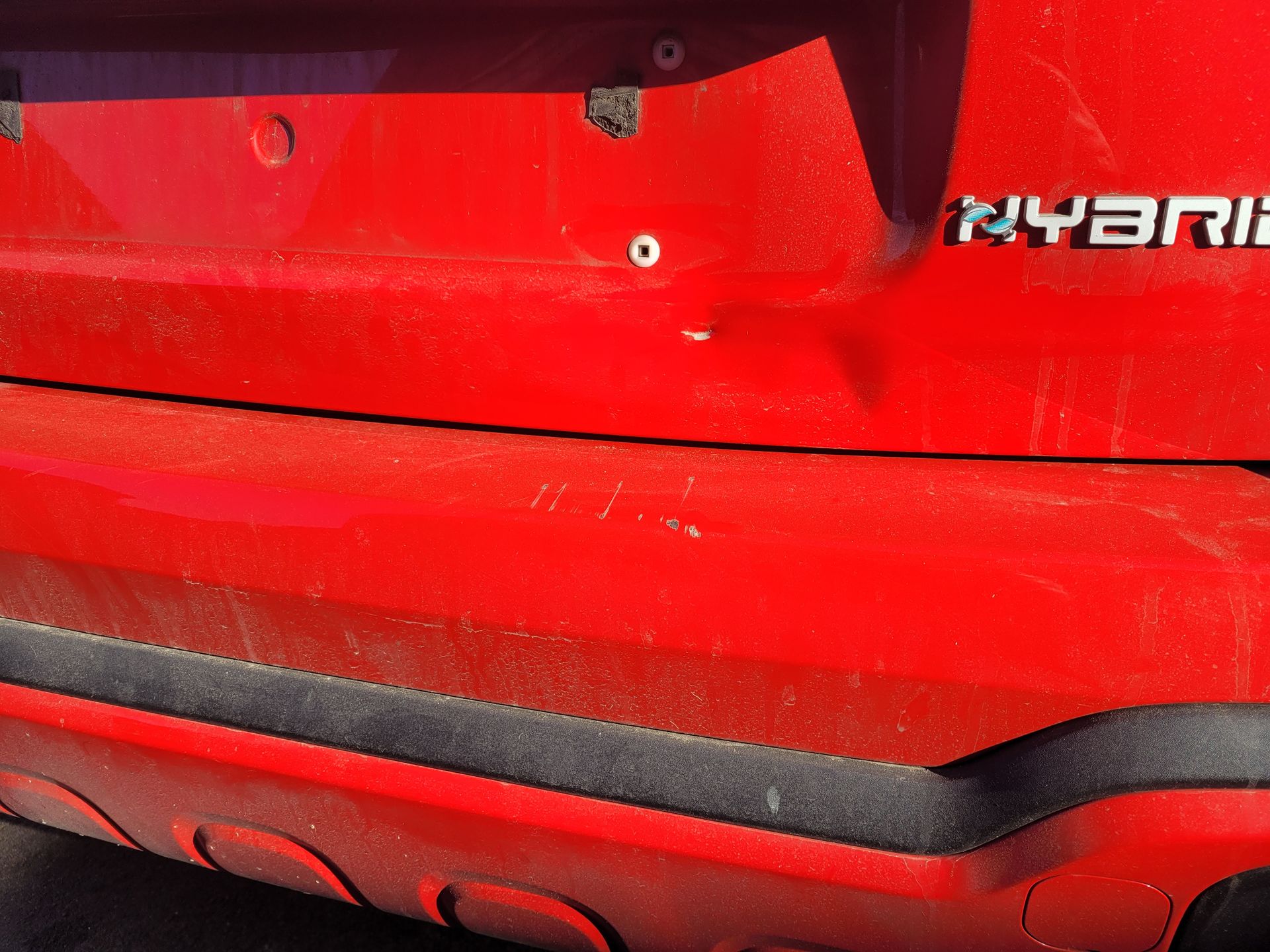 Red car dent before repair