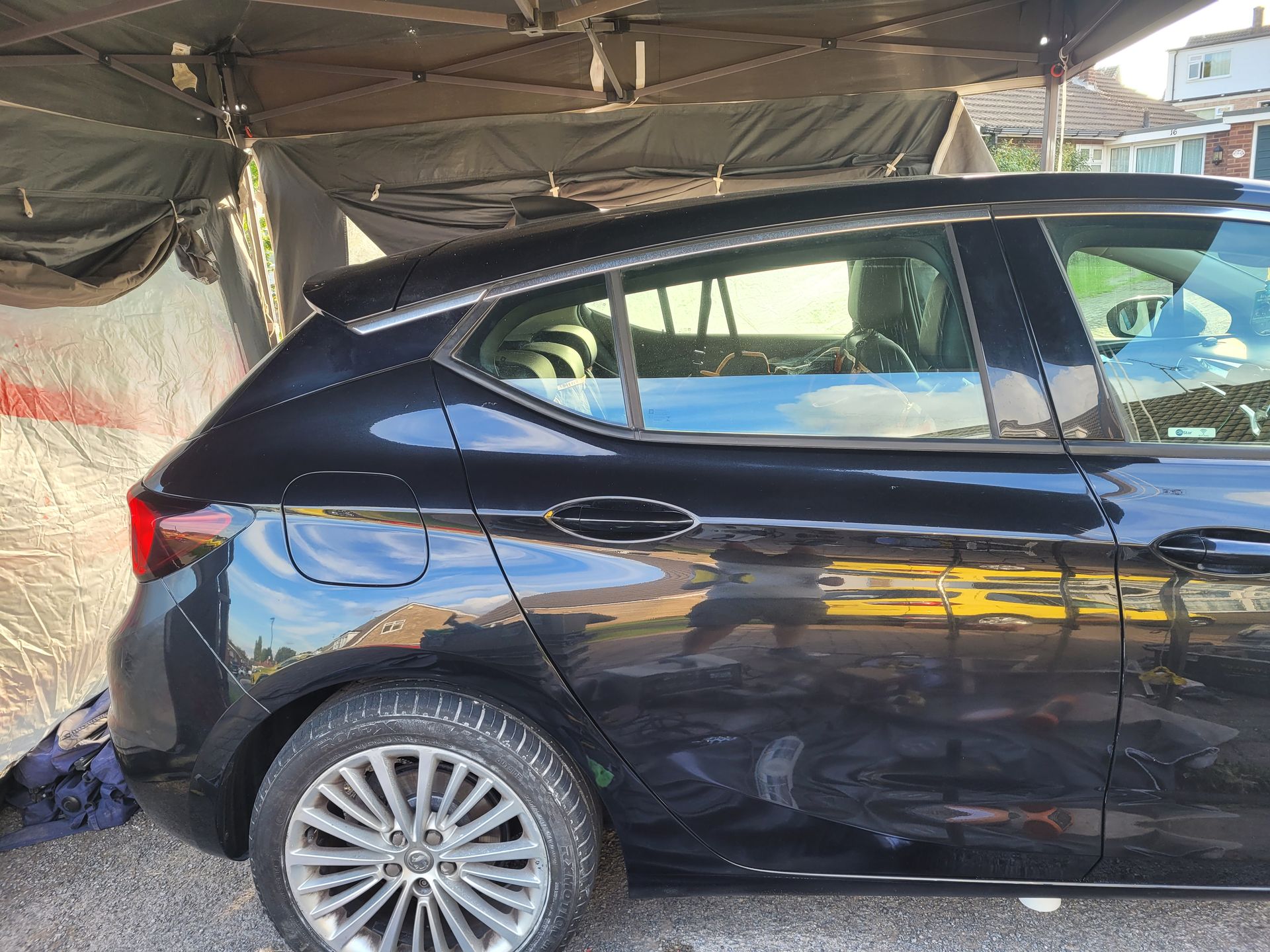 Black car dent after repair